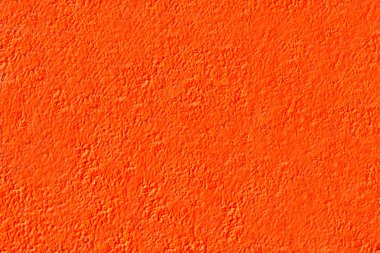 Arka plan kaba duvar, turuncu boya ile boyanmış. Soyut doku. Tasarım veya metin ve görüntülerin yerleşim için kullanılabilir. Yakın çekim.