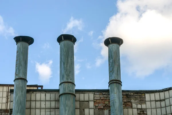 Pipes of the old boiler room against the blue sky. Abstract industrial background. Close-up.