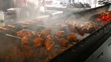 Kebap veya Barbekü restoran veya kafe kömür üzerinde yemek. Lezzetli ızgara et şiş üzerinde ile barbekü hazırlanıyor tarihinde kömürlerin Restoran mutfağında hazırlanır. Izgara et çevir.