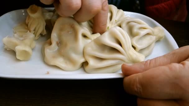 Man Eats Khinkali Turkish Ravioli Hands While Sitting Table Restaurant — Stock Video