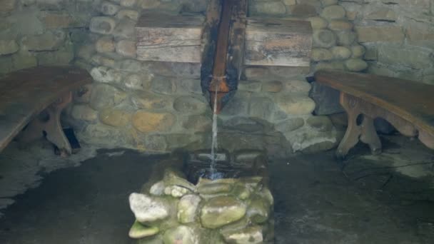 Stream Cold Drinking Water Flows Wooden Chute Stone Wall Cave — Stock Video