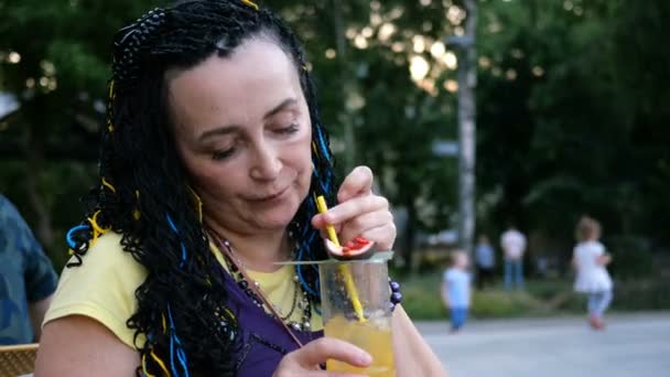 Senior Extravagant Woman Drinking Passion Fruit Cocktail Sitting Street Cafe — Stock Video