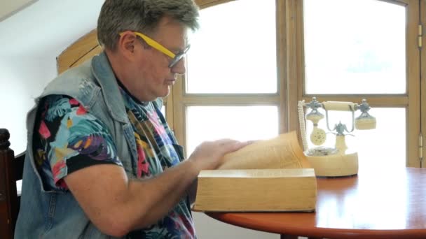 Handsome Mature Man Sits Table Scrolls Thick Old Book Perhaps — Stock Video