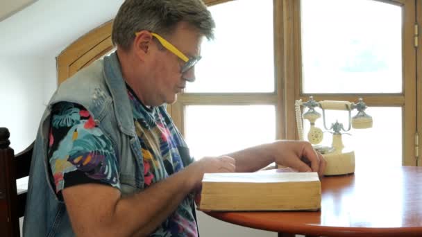 Handsome Mature Man Sits Table Scrolls Thick Old Book Perhaps — Stock Video