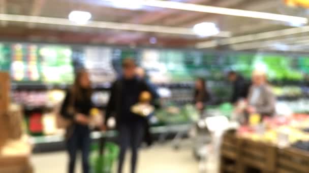 Compras en el supermercado moderno. Movimiento borroso abstracto de los clientes en la tienda de alimentos y comestibles, y el interior desenfocado. Productos y mercancías en el estante. Venta minorista moderna . — Vídeos de Stock