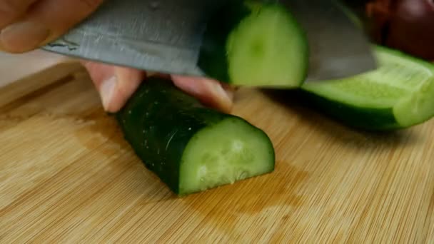 Aşçı elleri, salatalığı mutfak bıçağıyla kesti. Tahta kesme tahtasında kahvaltıda sebze vejetaryen salatası pişirmek için. Yakın plan.. — Stok video