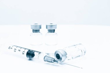 Uyuşturucu veya aşı ve 3 ml plastik şırınga ile izole iğne mavi rengi beyaz arka plan üzerinde şişe