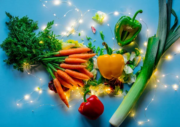 Fresh Carrots Leek Salad Pepper Fairy Lights Blue Background — Stock Photo, Image