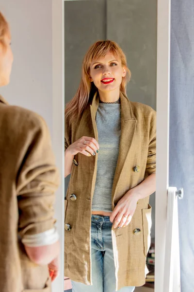 Woman dressing up near mirror at home. — Stock Photo, Image