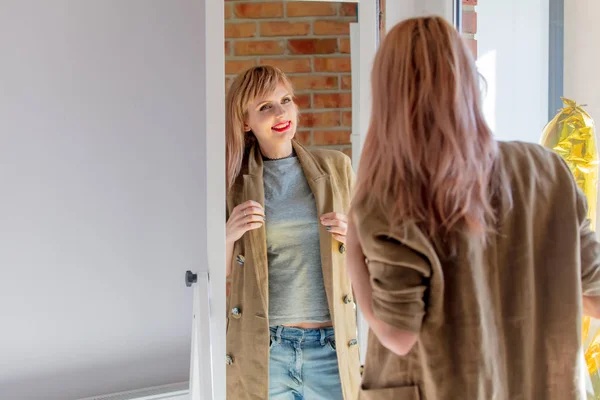 Frau verkleidet sich zu Hause in Spiegelnähe. — Stockfoto