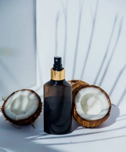 coconuts and skin care cream on white bacgkround