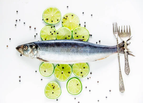 Fresh herring fish with lemons and peppers and wineglass on whit — Stock Photo, Image