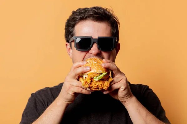 Bílý Muž Černé Košili Hamburgerem Žlutém Pozadí — Stock fotografie