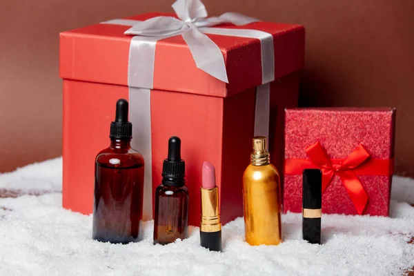 Cosmetics and gift boxes on a snow