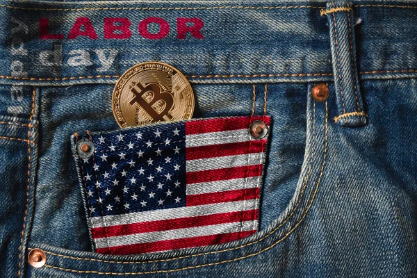 Happy Labor Day with BITCOIN (BTC) cryptocurrency concept. Golden Bitcoin in the pocket of jeans with the flag of United States of America (USA and Happy Labor Day text