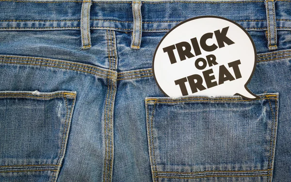 Happy Halloween day. Fashion background concept. Top View of Trick or Treat sign on denim jeans.