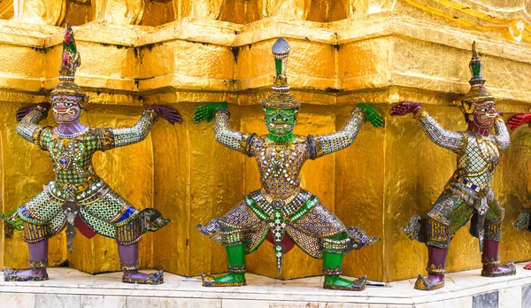 Guardian statues at the base of the Golden Chedi of Wat Phra Kaew, Grand Palace, Bangkok