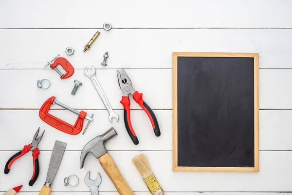 Flat lay of blank space blackboard with construction handy tools — Stockfoto