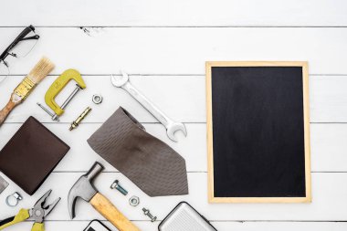 Flat lay of blank space blackboard with construction blue collar
