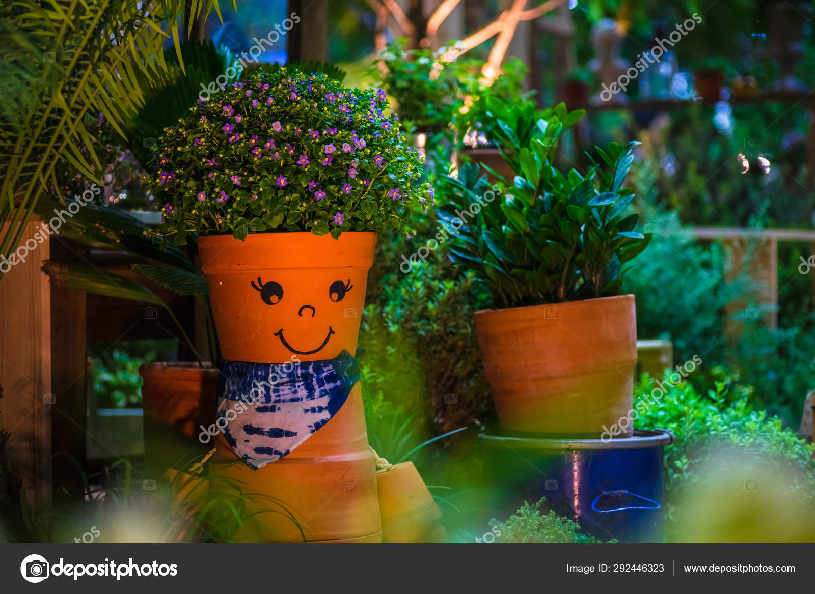 Smiling funny and cute flower pot in a garden. Home DIY Garden d