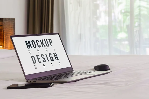 Mockup laptop on the bed. Relax and chill. Blank mock up screen