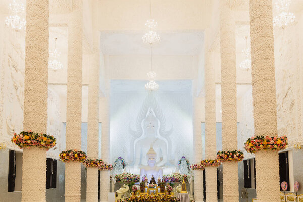 Beautiful White Buddha statue in a white hall at Wat Huay Pla Ku