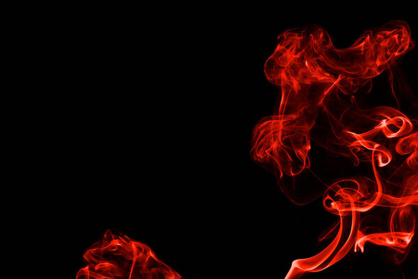 Abstract red orange color smoke isolated on black background. beautiful color smoke wallpaper backdrop.