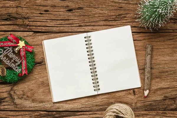 Top view of blank notebook on grunge wood  background with xmas