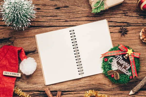 Top view of blank notebook on grunge wood  background with xmas