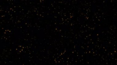 Soyut animasyon döngüsü, parlak altın yıldız parçacıkları siyah arkaplanda soldan sağa doğru akar. 4K 3D kusursuz altın halkalı bokeh parçacıkları havada uçuşuyor..