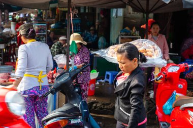 NHA TRANG, VIETNAM - SEPTEMBER 12: A Vietnamese woman sells donuts on the street market on September 12, 2018 in Nha Trang, Vietnam.