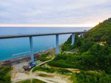 Zubova Schel Viyadüğü ve dağ tarafı ormanla dron görünümünü arka planda denizin içinde bulutlu yaz gün, Sochi, Rusya Federasyonu