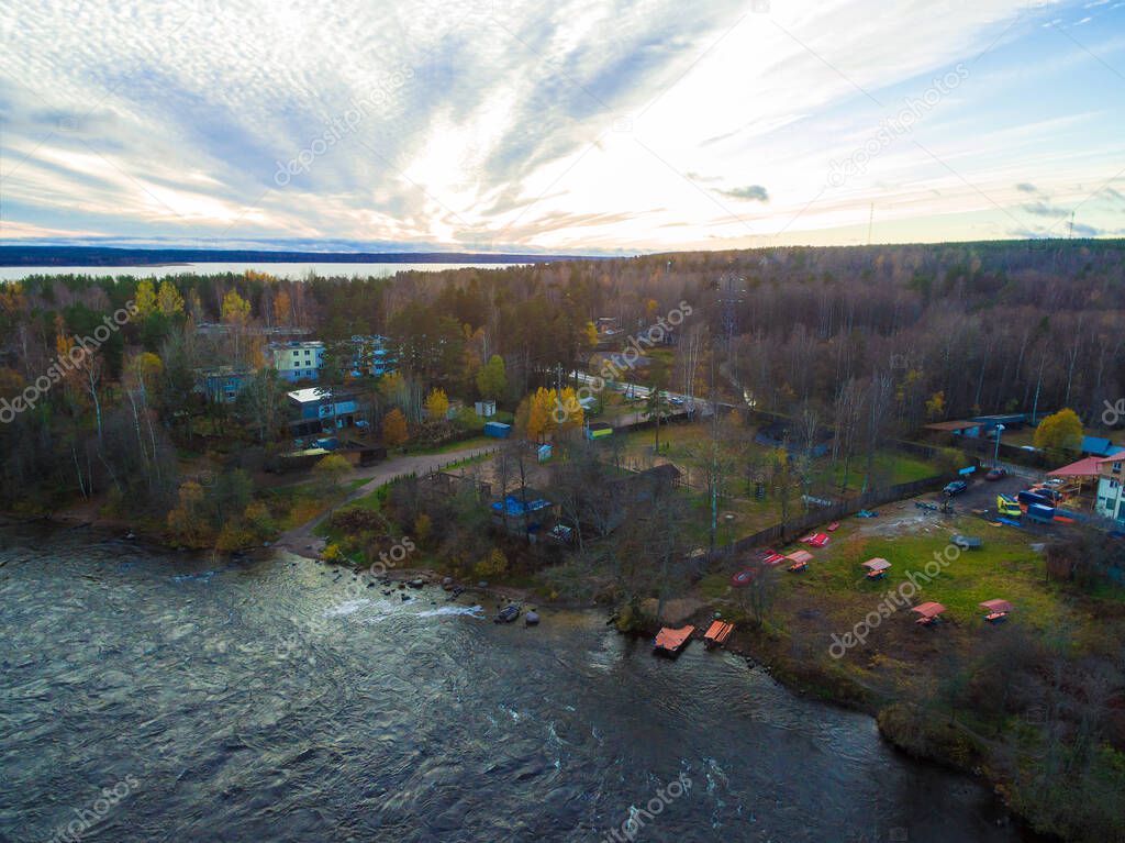 Drone view of the Vuoksi river, the forest and the settlement in autumn day, Losevo, Leningrad Oblast, Russia