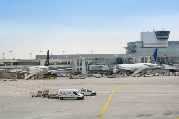 Modern airport scene with planes, control tower, hangars and terminals