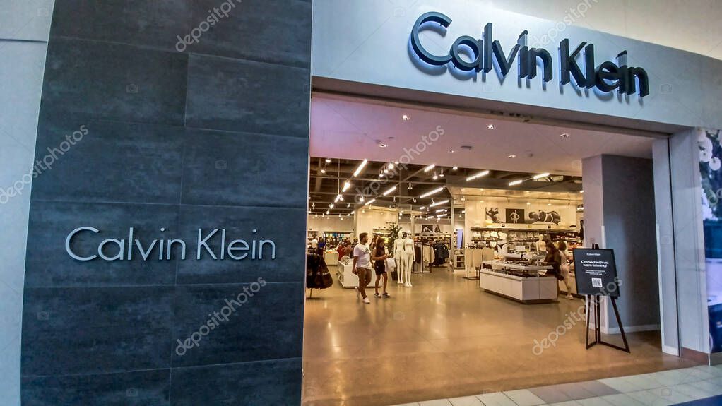 Toronto, ON, Canada - August 30, 2025: The Calvin Klein logo is mounted on a gray tile wall inside a retail store.