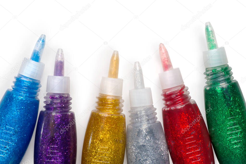 Set of open colored glitter glue tubes. Isolated on white with clipping path
