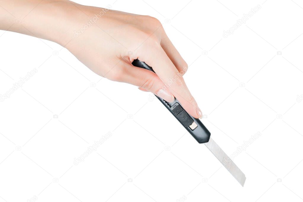 Woman hand cutting something with paper knife. Isolated on white, clipping path included