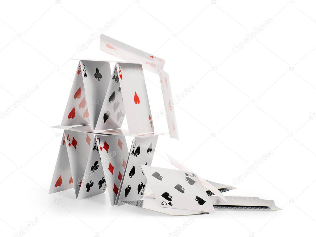 Crashed house of cards. Falling cards isolated on white, clipping path included