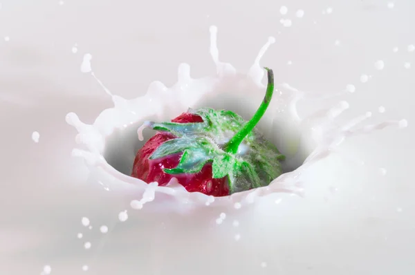 pure falling strawberry into milk with splash