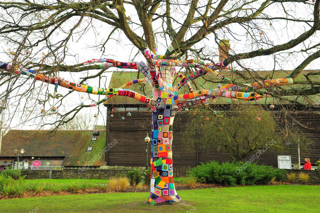 Patchwork knitted sleeve covering an oak tree, Stratford-upon-Avon, England