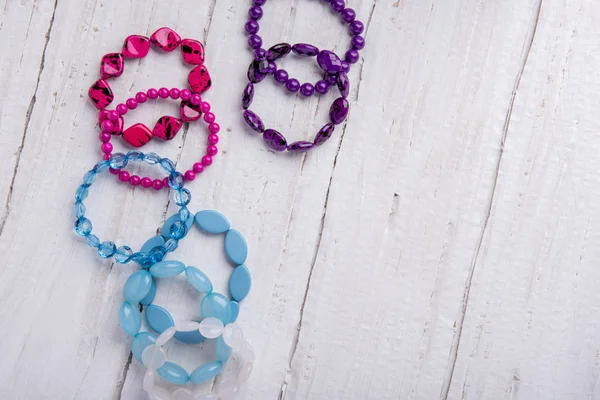Several Beautiful Bracelets Beads Stones Blue Pink Purple White Wooden — Stock Photo, Image