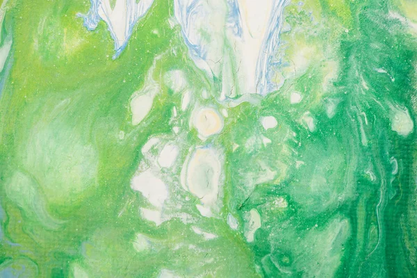 Beautiful abstract background of liquid acrylic in blue, white and green on canvas