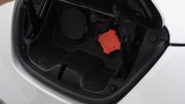 Şarj üzerine bir elektrikli araba koyarak bir adam closeup