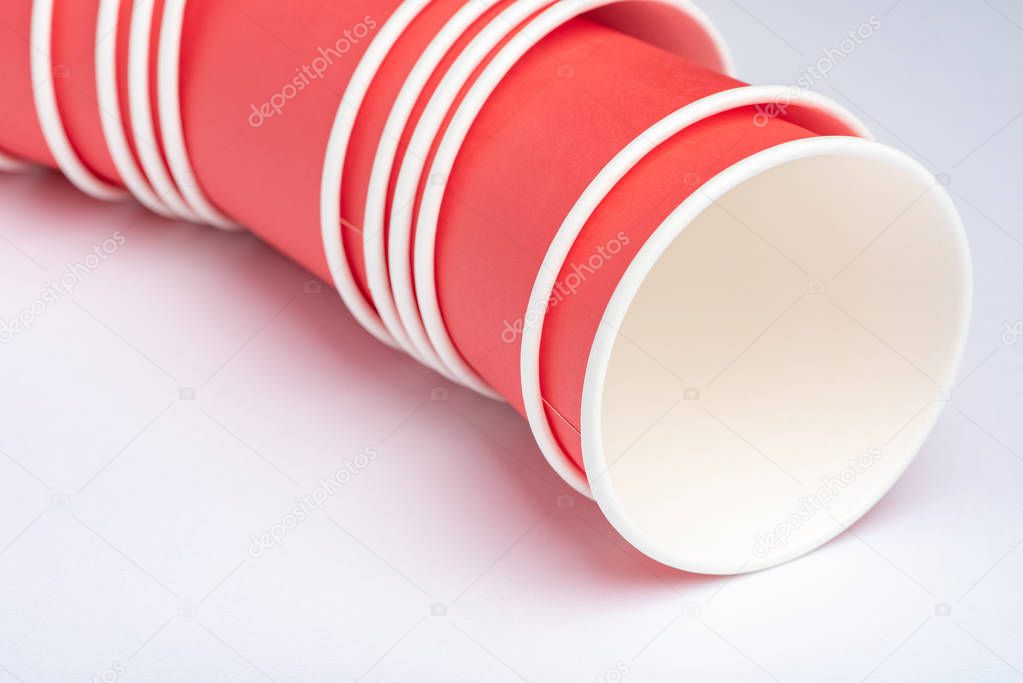Red eco-friendly paper cups for a party on a white background