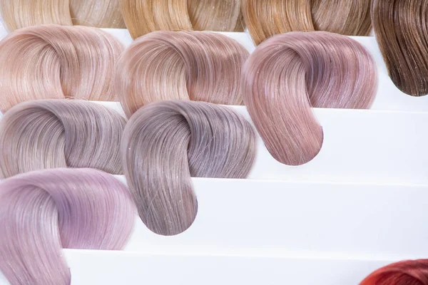 Hair color chart. Palette of dyed shiny hair samples. Catalog fo