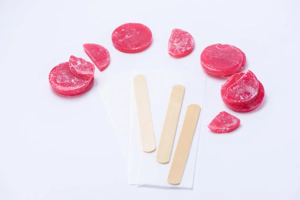 Red wax for depilation in tablets close up on a white background — Stock Photo, Image