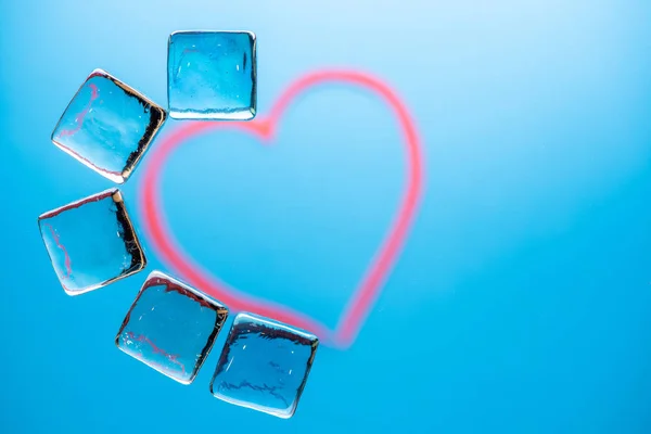 Stylish blue background with transparent ice-like cubes for drin