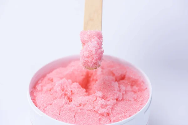Pink sugar scrub with the smell of strawberries for the depilati