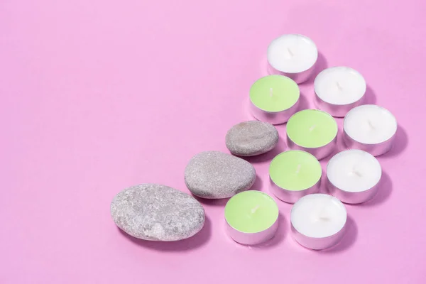 Drei Steine, grüne und weiße Kerzen für Hautpflege und Wellness auf einem — Stockfoto