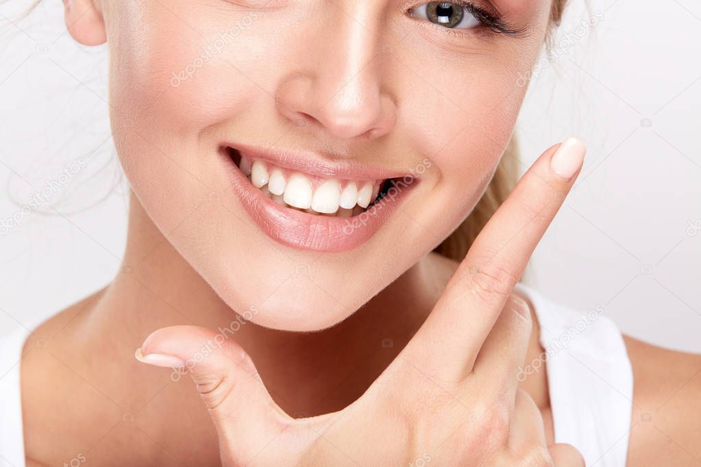 beautiful smiling woman showing white teeth, dentistry concept